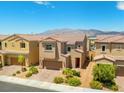 Two-story home boasts desert landscaping in the front yard, complemented by a two-car garage and mountain views in the background at 106 Rock Crossing Ave, North Las Vegas, NV 89031