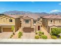 Two-story home with desert landscaping in front and a two-car garage, complemented by mountain views in the background at 106 Rock Crossing Ave, North Las Vegas, NV 89031