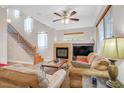 Inviting living room featuring a cozy fireplace and comfortable seating at 10601 Lessona St, Las Vegas, NV 89141