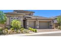 Charming single-story home with a two-car garage and desert landscaping at 12295 Skyracer Dr, Las Vegas, NV 89138
