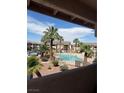 A refreshing community pool surrounded by lush palm trees and well-manicured landscaping at 1320 Driscoll Dr # 201, Las Vegas, NV 89128