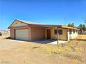 Single car attached garage with brick and siding exterior, plus a large lot at 1400 Silver Peak Ave, Pahrump, NV 89048
