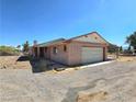 Single car attached garage with brick and siding exterior, plus a large lot at 1400 Silver Peak Ave, Pahrump, NV 89048