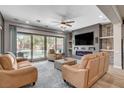Cozy living room with comfortable seating, a modern fireplace, and scenic backyard views at 2333 Indigo Island St, Henderson, NV 89044