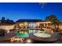 Stunning backyard features a sparkling pool and spa, perfect for outdoor entertaining at dusk at 2333 Indigo Island St, Henderson, NV 89044