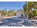 Lovely single-story house showcasing a landscaped front yard and attached two-car garage at 3129 White Rose Way, Henderson, NV 89014