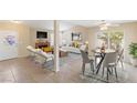 Bright living space with tile flooring, fireplace, ceiling fan, and slider to backyard at 3129 White Rose Way, Henderson, NV 89014