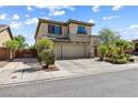 Inviting two-story home boasts a three-car garage and meticulous desert landscaping at 3405 Brook Song Ave, North Las Vegas, NV 89081
