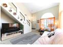 Inviting living room with high ceilings, staircase, and ample natural light at 3425 Yorkminster St, Las Vegas, NV 89129
