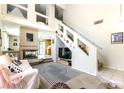Bright living room featuring a fireplace, staircase, and contemporary decor at 3425 Yorkminster St, Las Vegas, NV 89129