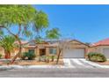 Single-story home with desert landscaping, a covered entryway, and a two car garage at 3604 Cantura Crest Ct, North Las Vegas, NV 89031