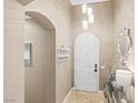 An elegant entryway with arched doorway and stylish lighting at 4 Via Centrale # 1, Henderson, NV 89011