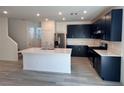 Modern kitchen with black cabinets, stainless steel appliances, and a large center island at 4266 Yucca Brevi Ave, Las Vegas, NV 89139