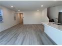 Open-concept living room featuring a kitchen island, tile floors and neutral paint palette at 4266 Yucca Brevi Ave, Las Vegas, NV 89139