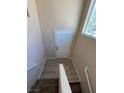 Stairway to a well-lit entryway with a white door and light hardwood flooring at 5316 Fireside Ranch Ave, Las Vegas, NV 89131
