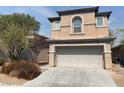 Beige two-story home with a two-car garage, complemented by a mature tree in the front yard at 5316 Fireside Ranch Ave, Las Vegas, NV 89131
