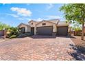 Charming single-story home featuring a three-car garage and beautifully paved driveway at 5601 Mackenzie Park Ct, Las Vegas, NV 89130
