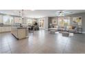 Bright and open living space featuring an island, modern decor, and dining area at 5601 Mackenzie Park Ct, Las Vegas, NV 89130