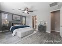 A staged main bedroom featuring neutral paint, ceiling fan and coordinated furnishings at 5601 Mackenzie Park Ct, Las Vegas, NV 89130