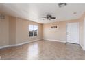 Neutral living room with large tile floor and window offering natural light at 6800 E Lake Mead Blvd # 2076, Las Vegas, NV 89156