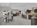Spacious open-plan living space featuring kitchen, dining, and living areas at 7230 Fresh Harvest Ave, Las Vegas, NV 89131