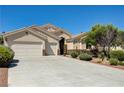 Well-maintained single-story house with manicured landscaping, a three-car garage and decorative stone accents at 8204 Turbys Treehouse Pl, Las Vegas, NV 89131