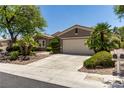 Inviting single-story home featuring a well-manicured lawn, desert landscaping, and an attached two-car garage at 10463 Luna Magico Ave, Las Vegas, NV 89135