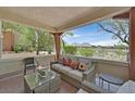 Outdoor patio with comfortable seating and views of the mountains at 10640 Amber Ridge Dr # 101, Las Vegas, NV 89144