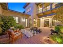 Charming courtyard with outdoor seating and a unique oversized chess set on brick pavers at 1404 Reisling Ct, Las Vegas, NV 89144