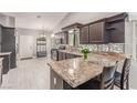 Spacious kitchen features granite countertops, modern appliances, and ample storage, perfect for cooking and entertaining at 1761 Summerwood Cir, Henderson, NV 89012