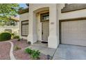 Welcoming entrance with neutral paint, a well-manicured yard, and a front-facing garage at 198 Winterport St, Henderson, NV 89074
