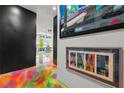 Hallway with colorful epoxy flooring and art on the walls at 200 Hoover Ave # 1813, Las Vegas, NV 89101