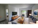 Bright living room features modern furniture, sliding glass doors, and a neutral color palette at 2615 W Gary Ave # 2061, Las Vegas, NV 89123