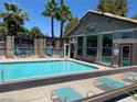 Community pool with ample seating, shaded areas, and access to the clubhouse for resident's leisure at 2750 S Durango Dr # 2141, Las Vegas, NV 89117