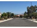 View of quiet residential street with well-maintained homes and mountain views at 3104 Birch Grove Ct, Las Vegas, NV 89134
