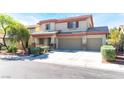 Charming two-story home with a three-car garage, desert landscaping, and mature trees at 3309 Green Ice Ave, North Las Vegas, NV 89081