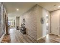 Stylish hallway featuring a decorative brick wall, wood-look floors, and modern decor at 365 Sapphire Rock Ave, Las Vegas, NV 89183