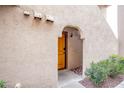Inviting courtyard entry featuring a wooden front door, rock landscaping, and a covered entrance way at 4083 Nook Way # A, Las Vegas, NV 89103