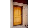 Close-up of the charming front door with elegant hardware and an adjacent wall-mounted light fixture at 4083 Nook Way # A, Las Vegas, NV 89103