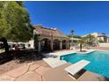 Backyard featuring a swimming pool, a diving board, a covered patio and desert landscaping at 4542 Amber Canyon Ln, Las Vegas, NV 89129