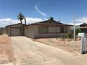 Wide shot of single-story home featuring desert landscaping and a driveway at 462 Crestway Rd, Henderson, NV 89015