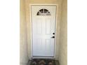 Clean white front door with half-round window detail set in stucco wall at 462 Crestway Rd, Henderson, NV 89015