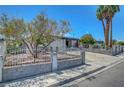 Charming single-story home featuring a unique gated front yard with drought tolerant landscaping and curb appeal at 4807 Sacks Dr, Las Vegas, NV 89122