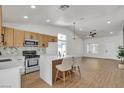 Modern kitchen with island seating, stainless appliances, and open layout to the living room at 4911 Ranchodomingo Ct, North Las Vegas, NV 89031