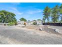 Charming single-story home with a stucco facade, double front doors, and ample gravel parking area at 5008 Donnie Ave, Las Vegas, NV 89130