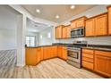 Well-equipped kitchen featuring stainless steel appliances, attractive wood cabinets, and sleek countertops at 5967 Sun Appello Ave, Las Vegas, NV 89122