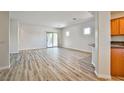 Bright and airy living room with hardwood floors and sliding glass doors to the backyard at 5967 Sun Appello Ave, Las Vegas, NV 89122