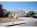 Charming single story home with a two car garage and desert landscaping at 6131 Pumpkin Patch Ave, Las Vegas, NV 89142