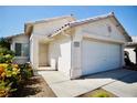 Close up view of a single story home with desert landscaping and a two car garage at 6131 Pumpkin Patch Ave, Las Vegas, NV 89142