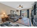 Bright living room with tile flooring and sliding doors to outdoor patio at 6141 Tokara Ave, Las Vegas, NV 89122